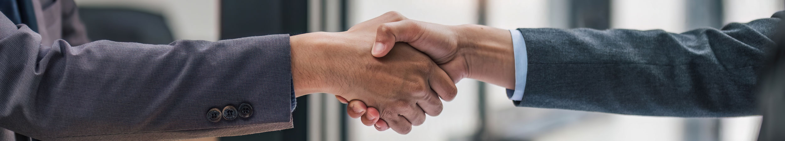 photo of two people shaking hands