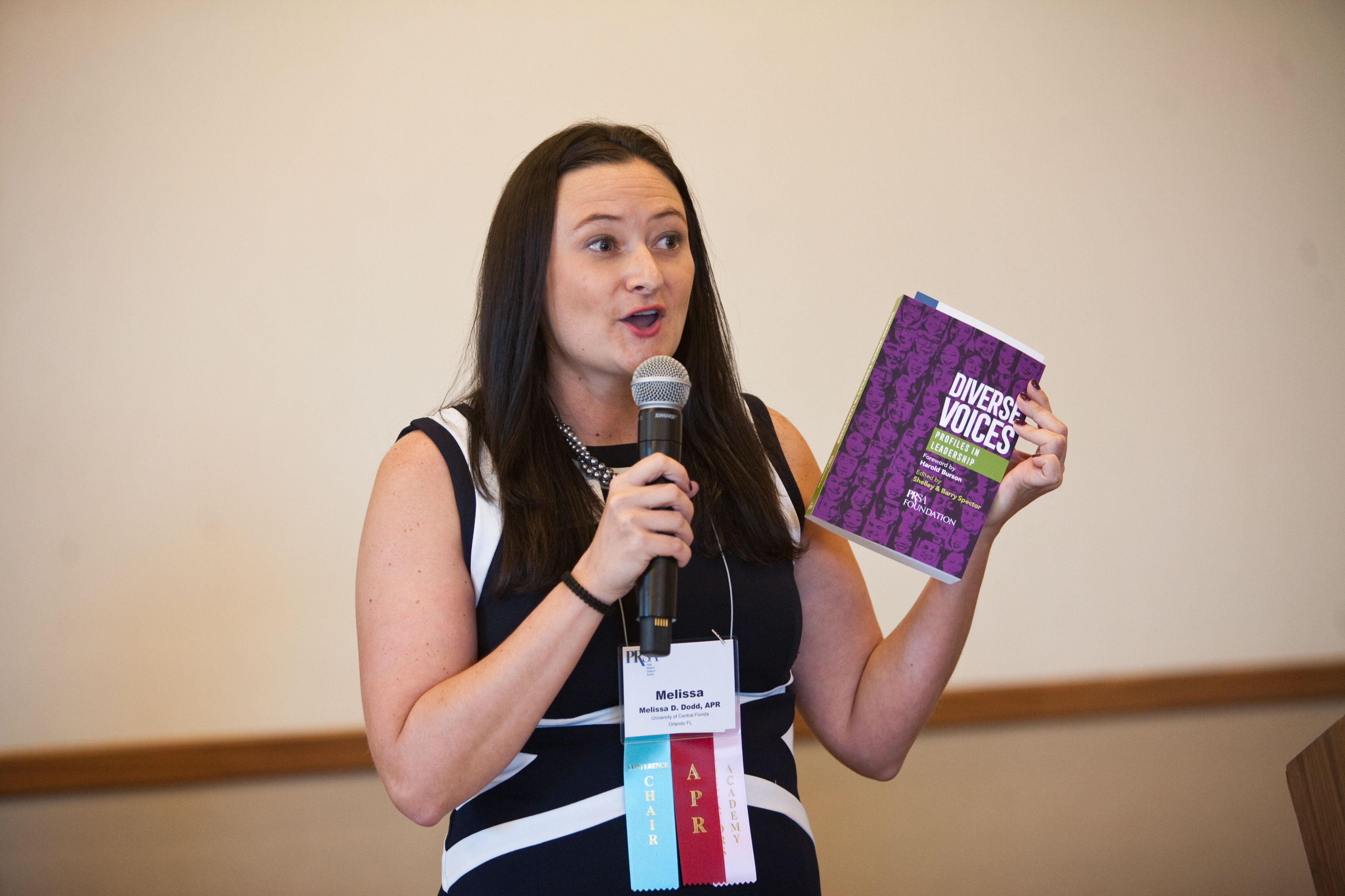 Member holding a Diverse Voices book