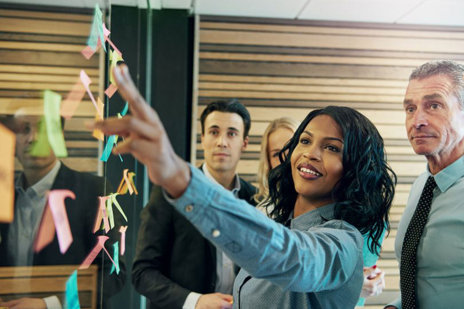 woman pointing at post-it notes