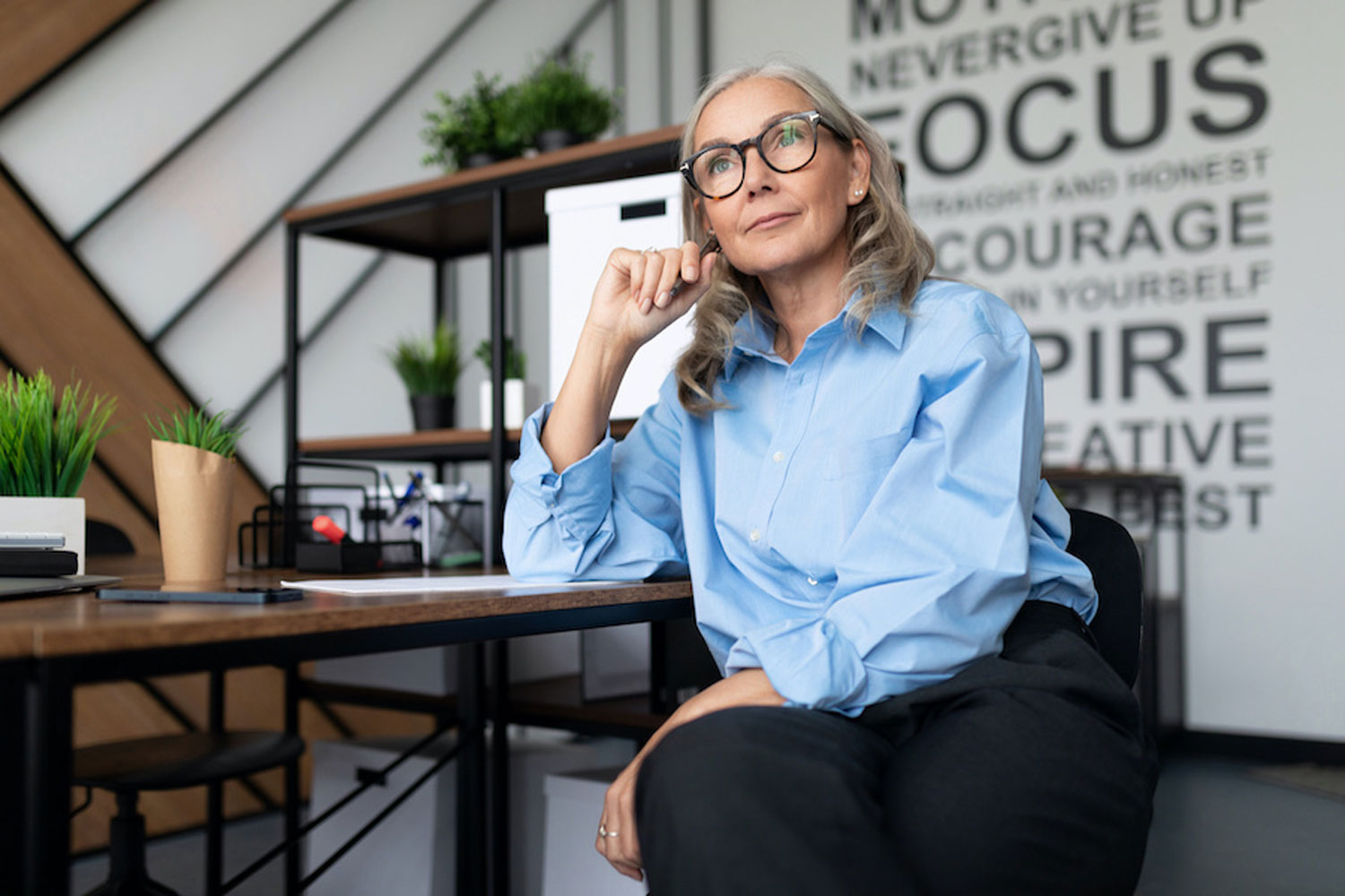 seated woman with glasses deep in thought