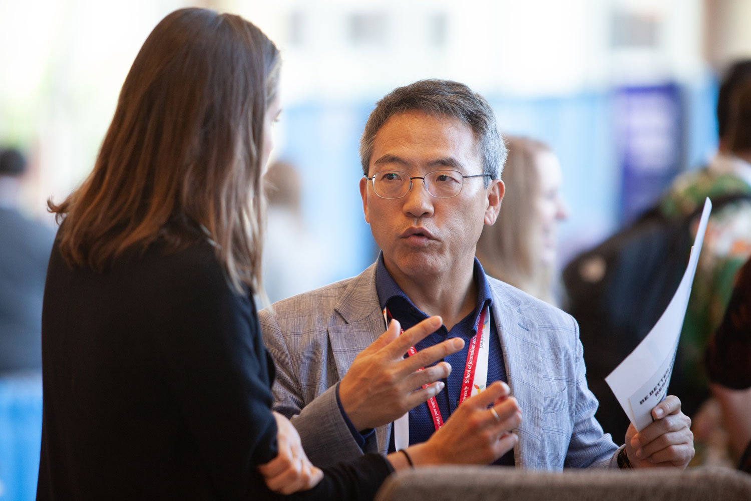 two professionals conversing at conference