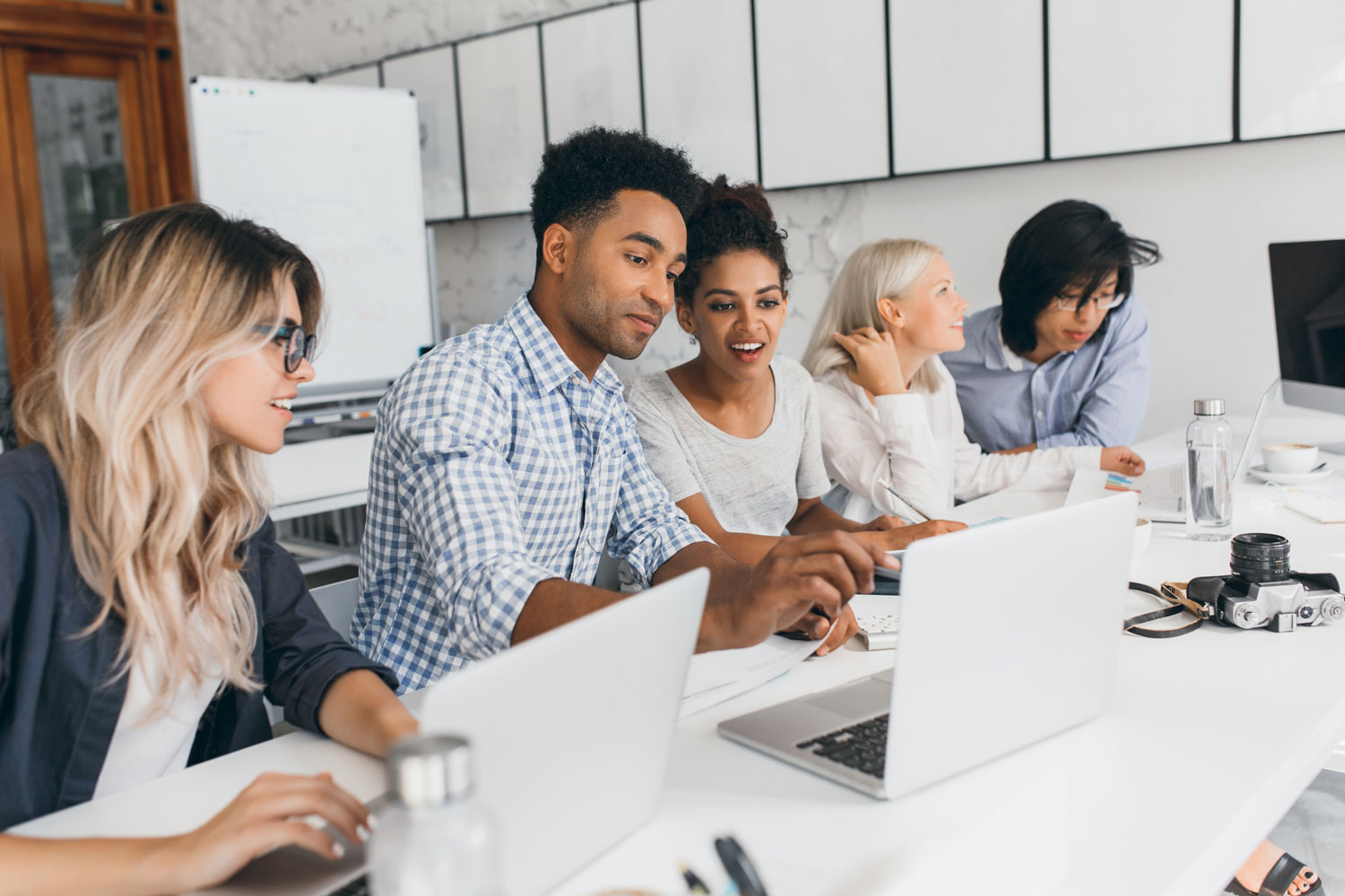 group of young adults with laptops