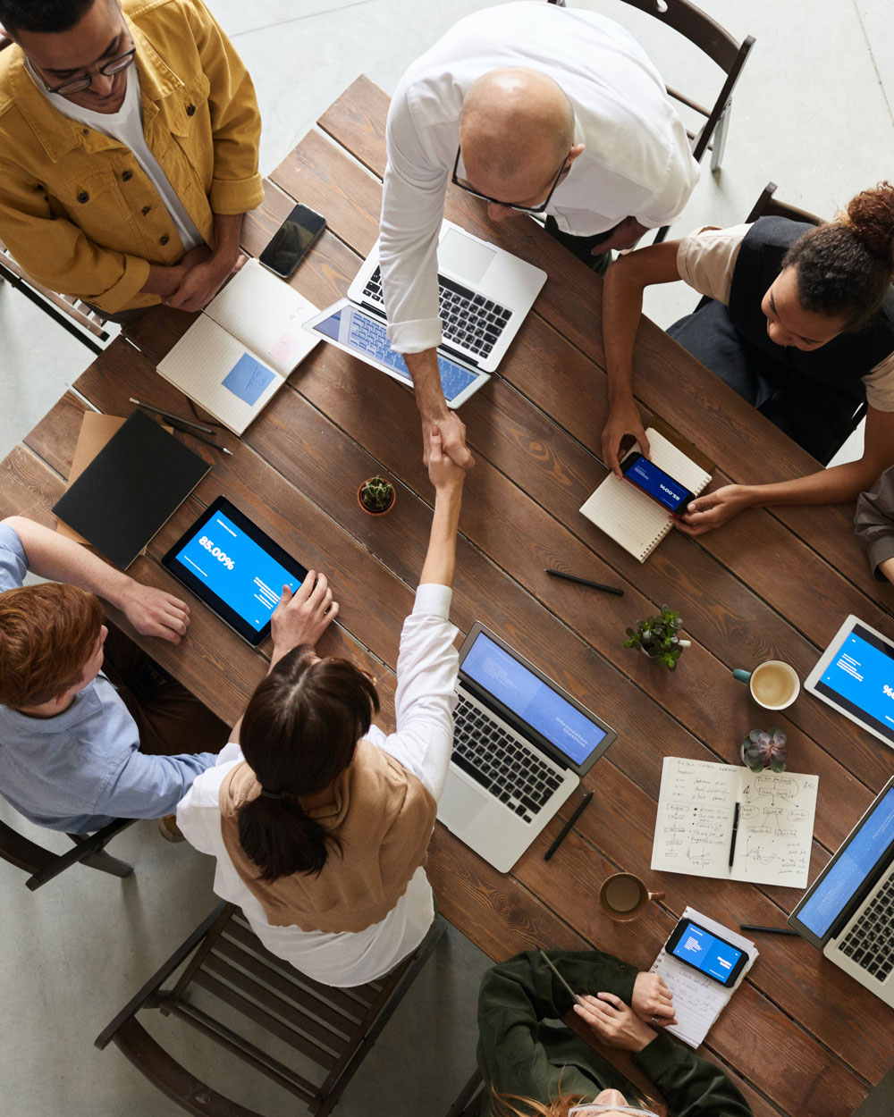 handshake across a conference table