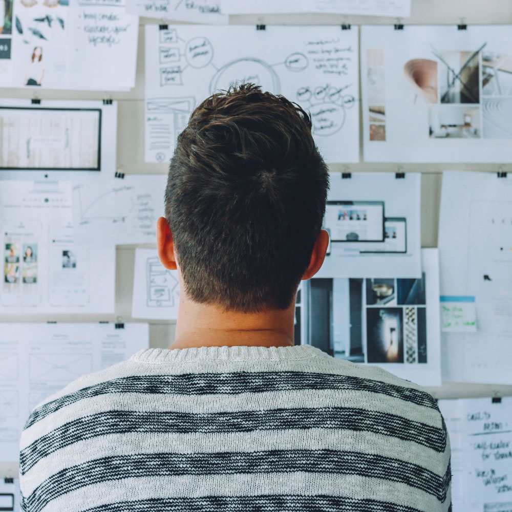 man facing whiteboard with complex writing