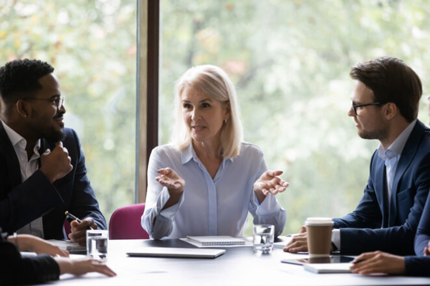 Three people at conference table