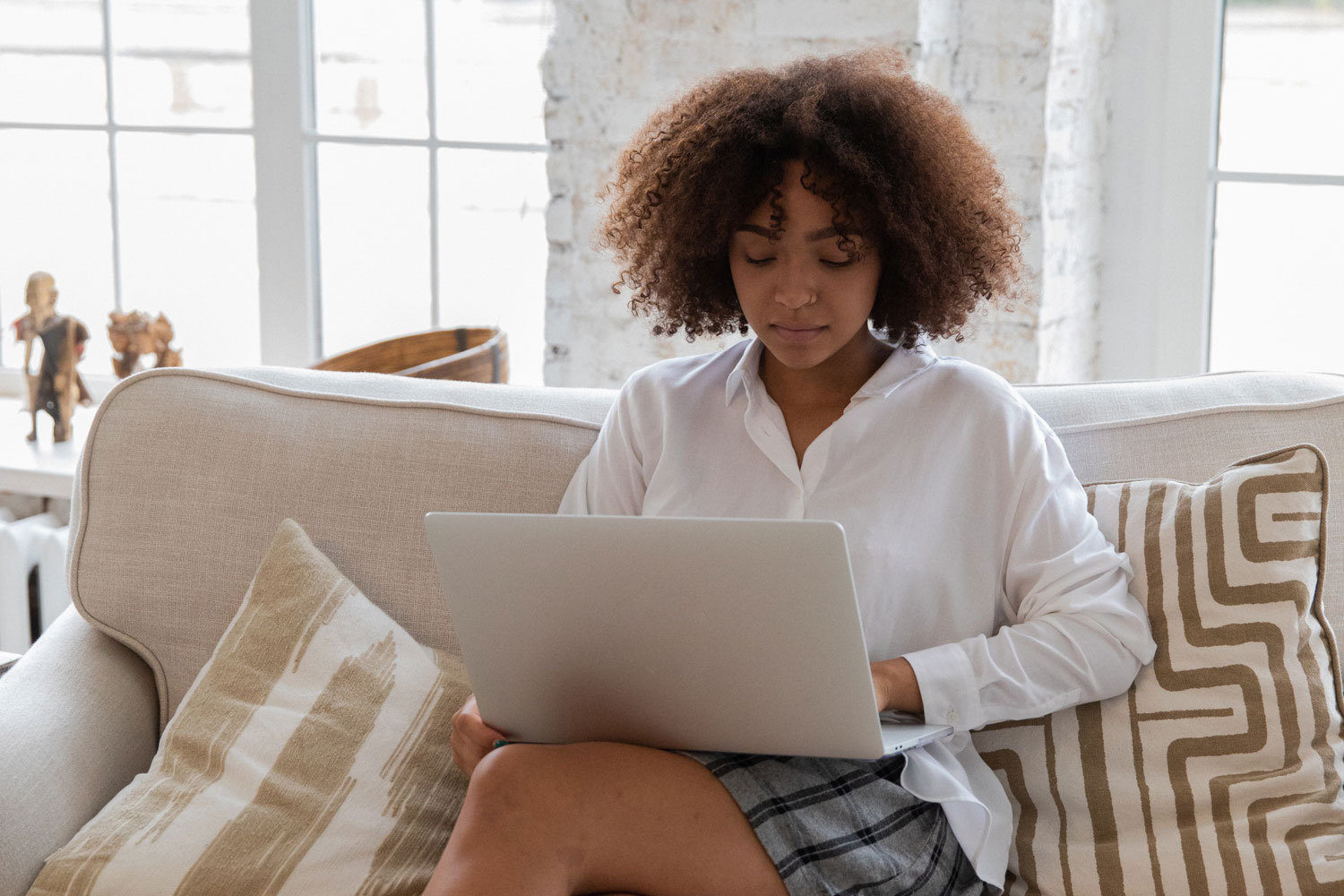 Woman on sofa with laptop