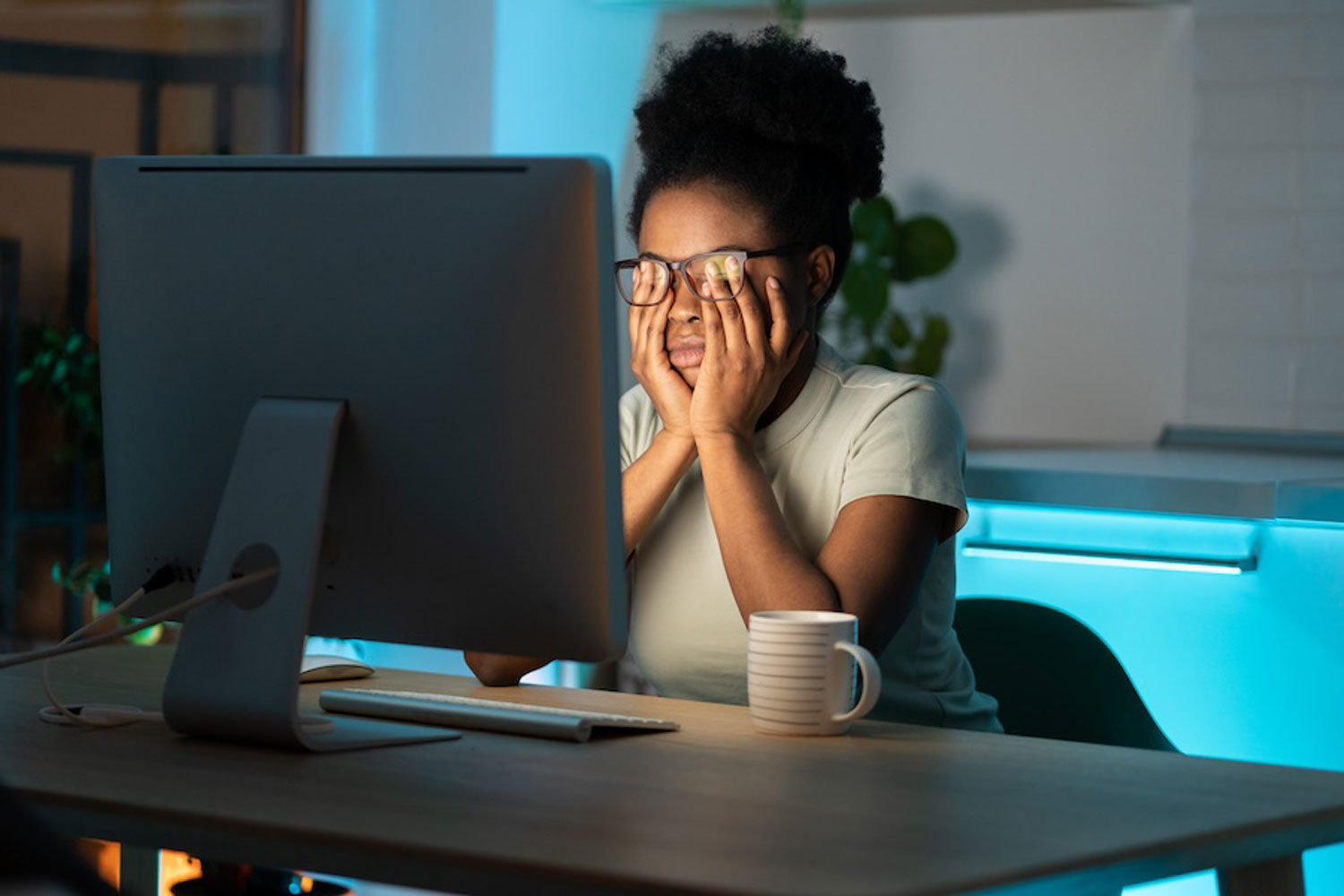 overworked woman in front of laptop