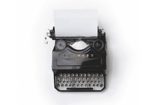 An overhead image of a black typewriter