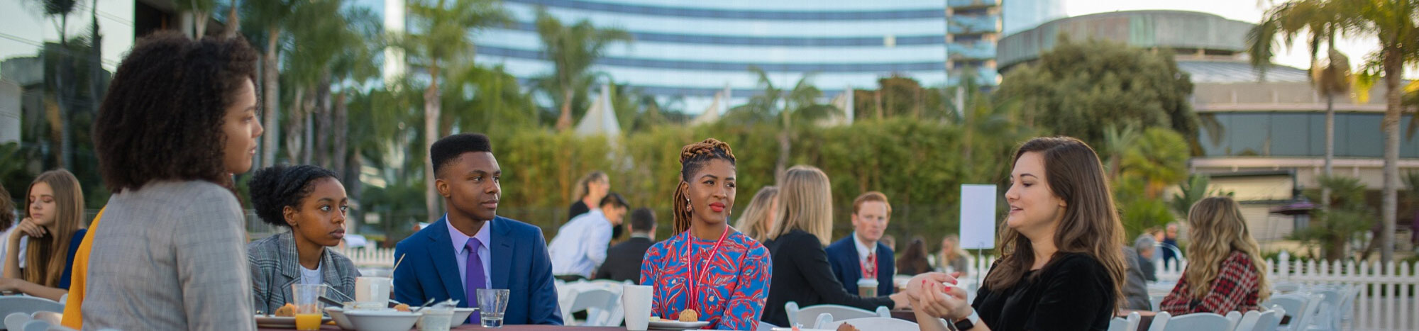 Students talking at outdoor dinner table