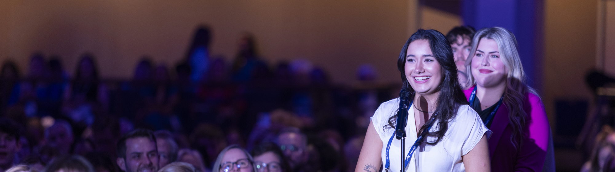 Seven PRSSA students in front of logo backdrop