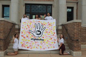 LSU team members holding their campaign poster at the Bateman Competition