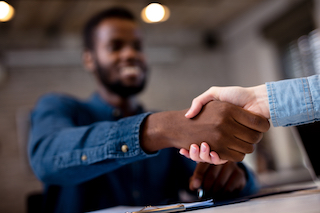 a man shaking a woman's hand