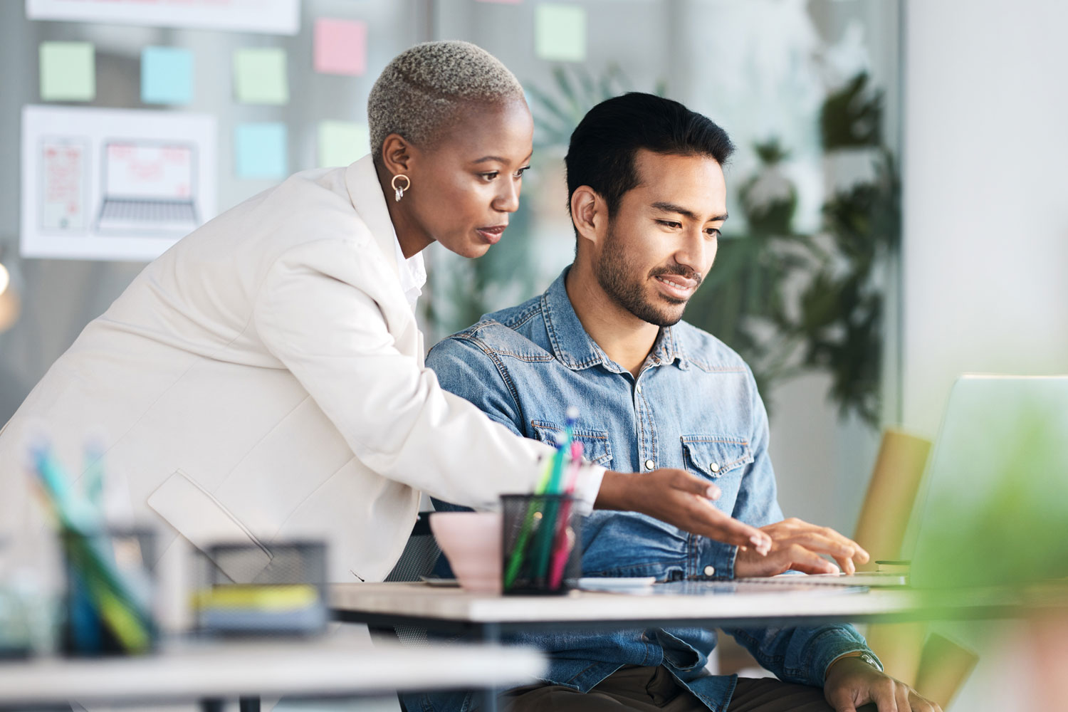 male and female adults looking at laptop male and female adults looking at laptop